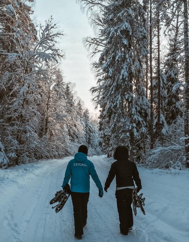 Räätsamatkalised jalutamas, räätsad käes, lumine mets
